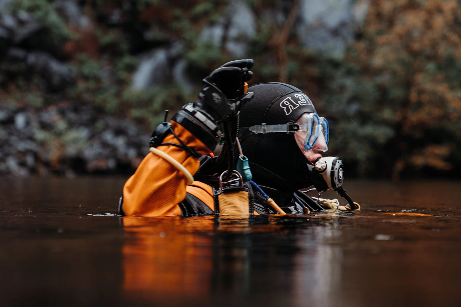 Scuba training equipment staged beside a swimming pool